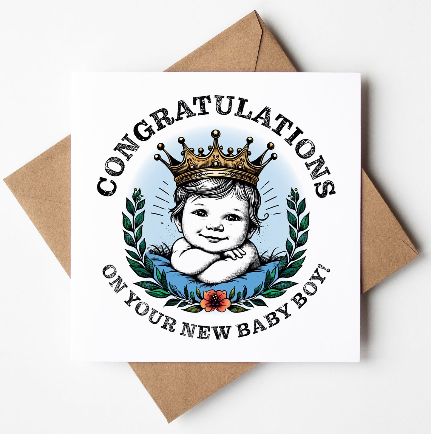 A typographic greetings card titled "Congratulations On Your New Baby Boy! Crown Card" showcases a smiling baby boy adorned with a golden crown, encircled by a wreath of leaves and a flower. The card is accompanied by the message, "Congratulations on your new baby boy!" and is paired with a brown envelope.