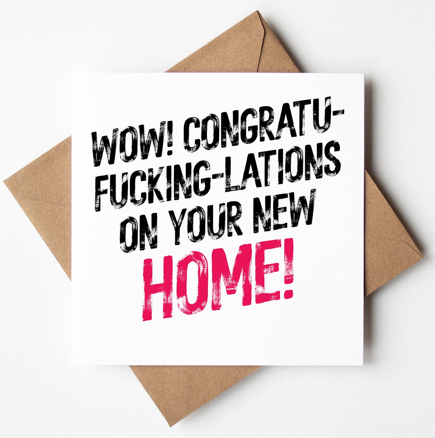The "Congratulations On Your New Home Card" features bold text that exclaims, "Wow! Congratu-fucking-lations on your new home!" with the word "home" highlighted in pink while the rest of the text is in black. This cheeky card comes with a brown envelope.