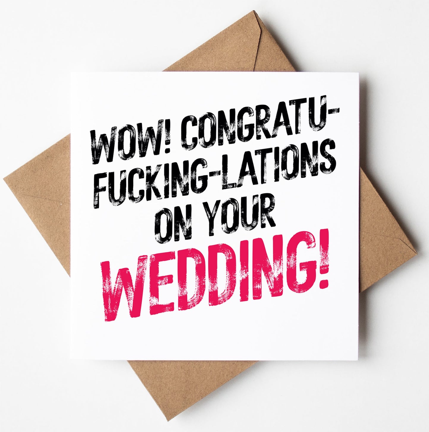 A card from the "Congratulations On Your Wedding! Sweary Card" collection, perched on a brown envelope, boldly proclaims, "WOW! CONGRATU-FKING-LATIONS ON YOUR WEDDING!" in striking black and pink text. This edgy design adds flair to its cheeky congratulations, while its biodegradable bag ensures that it's both entertaining and environmentally friendly.