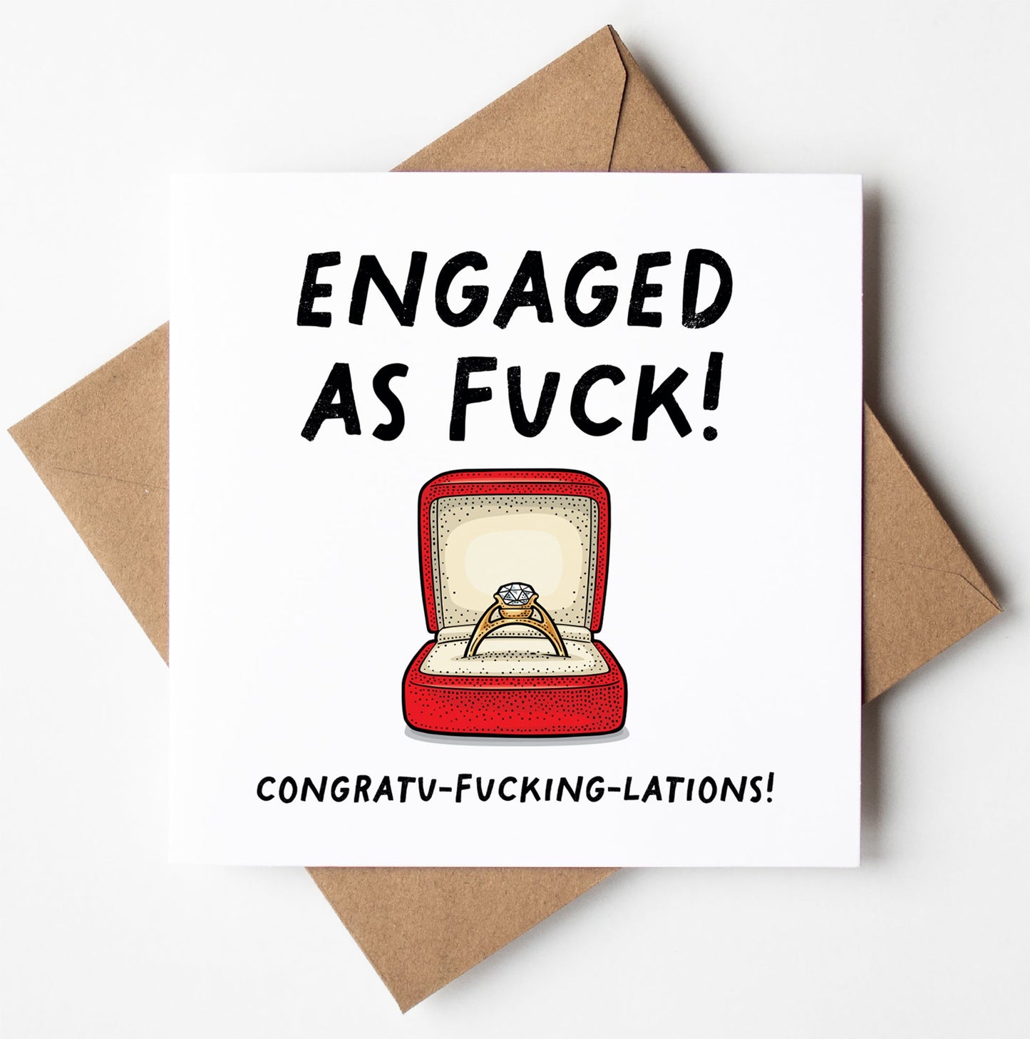 The "Engaged As Fuck!" card features an engagement ring in a red box with "Congratu-fucking-lations!" beneath it. It's packaged in a brown envelope and available for worldwide shipping, making it perfect for sharing laughs and love.