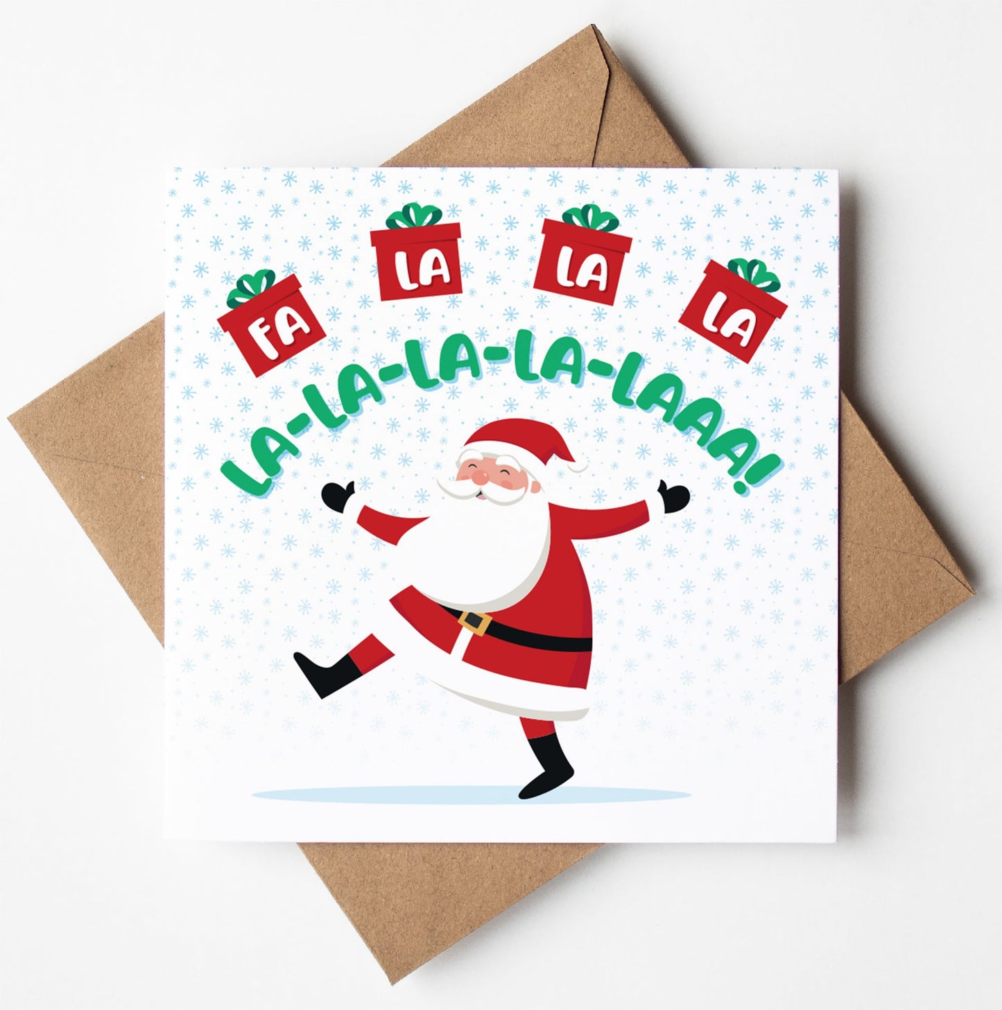 A humorous Christmas card named "Fa La La La Laaa" showcases Father Christmas in a dance, encircled by the phrase "Fa la la la la la-la-laaa!" and five red gift boxes with green ribbons. The background is adorned with light blue snowflakes, and an envelope is included beneath this festive card.
