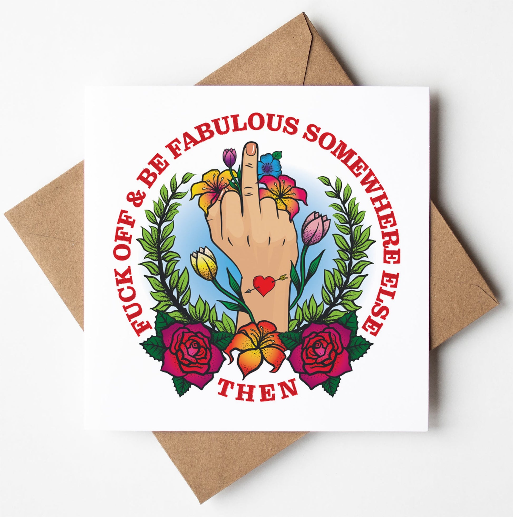 The Fuck Off Fabulous Tattoo Card features an illustration of a hand with a raised middle finger, encircled by vibrant flowers and leaves. The striking red text declares, "FUCK OFF & BE FABULOUS SOMEWHERE ELSE THEN." It's blank inside for your personalized message and includes a brown envelope. Plus, it ships worldwide.