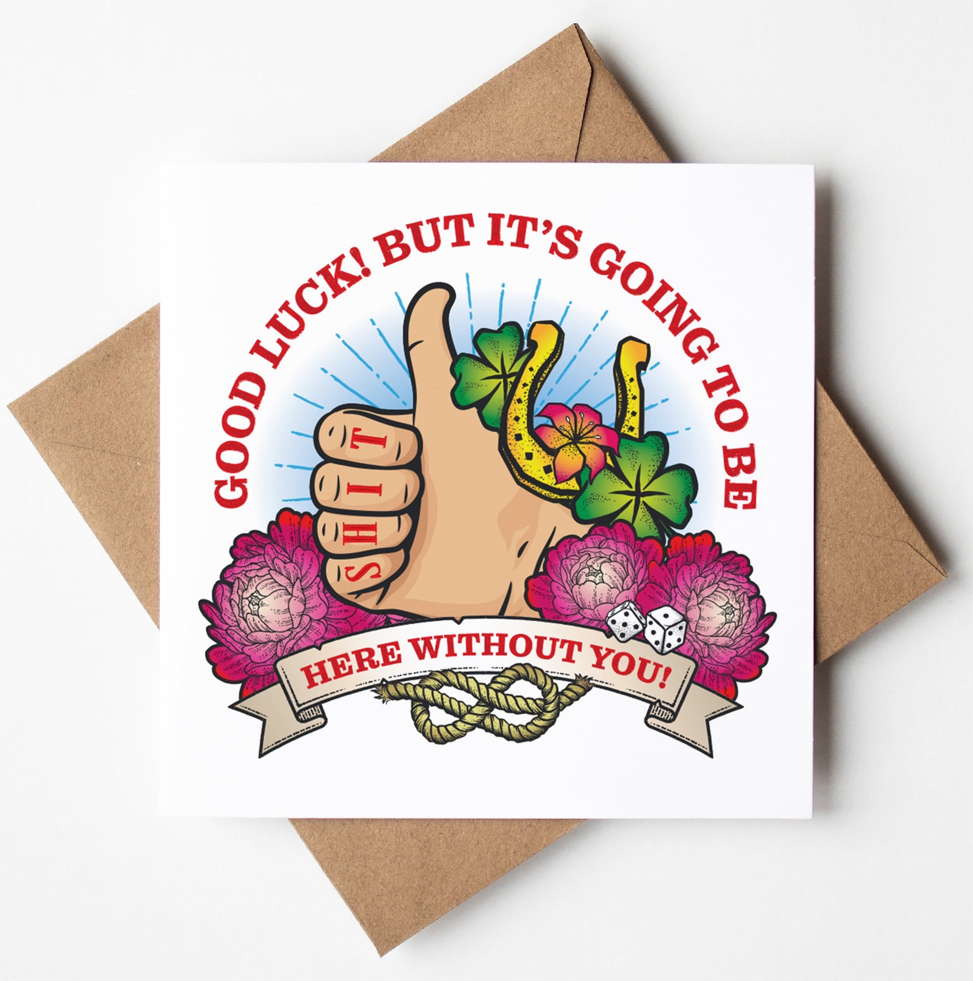 The Good Luck, Going To Be Shit Here Tattoo Card features a tattoo-inspired design with a thumbs-up, clover, horseshoe, dice, and pink flowers, plus the message: "Good luck! But it's going to be shit here without you!" Includes brown envelope.
