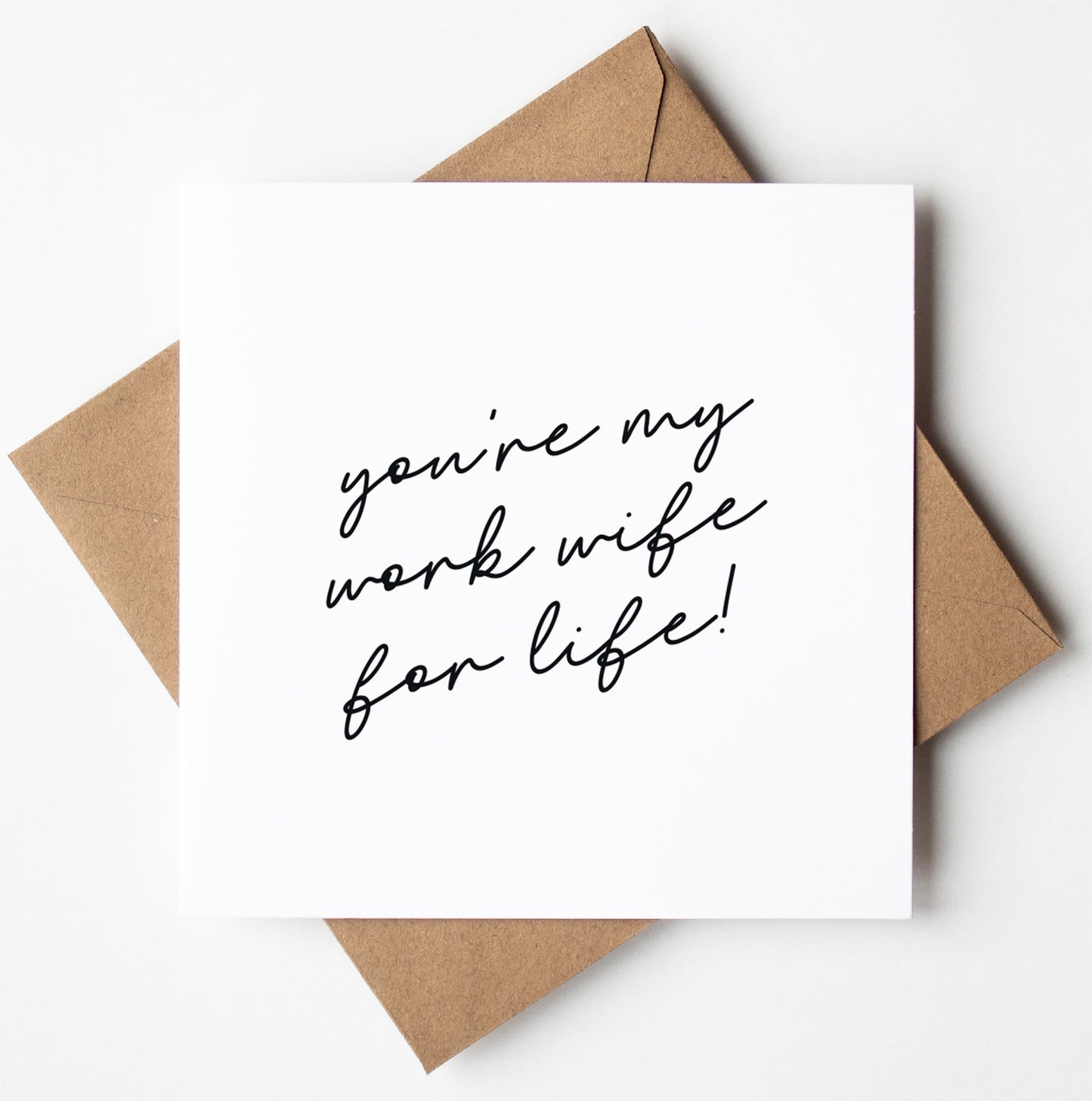 The "Work Wife For Life! Script Card" featuring the handwritten message "you're my work wife for life!" is displayed on top of a kraft paper envelope, set against a clean white background, ready for worldwide shipping.
