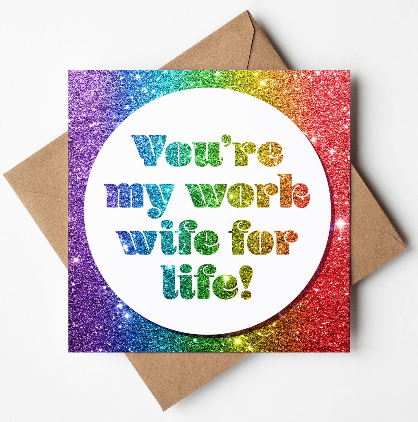 The "Work Wife For Life! Glitter Card" features a shimmering rainbow backdrop and was crafted in Wales. The center text reads, "You're my work wife for life!" This card is an ideal choice as a leaving card and comes with a brown envelope.