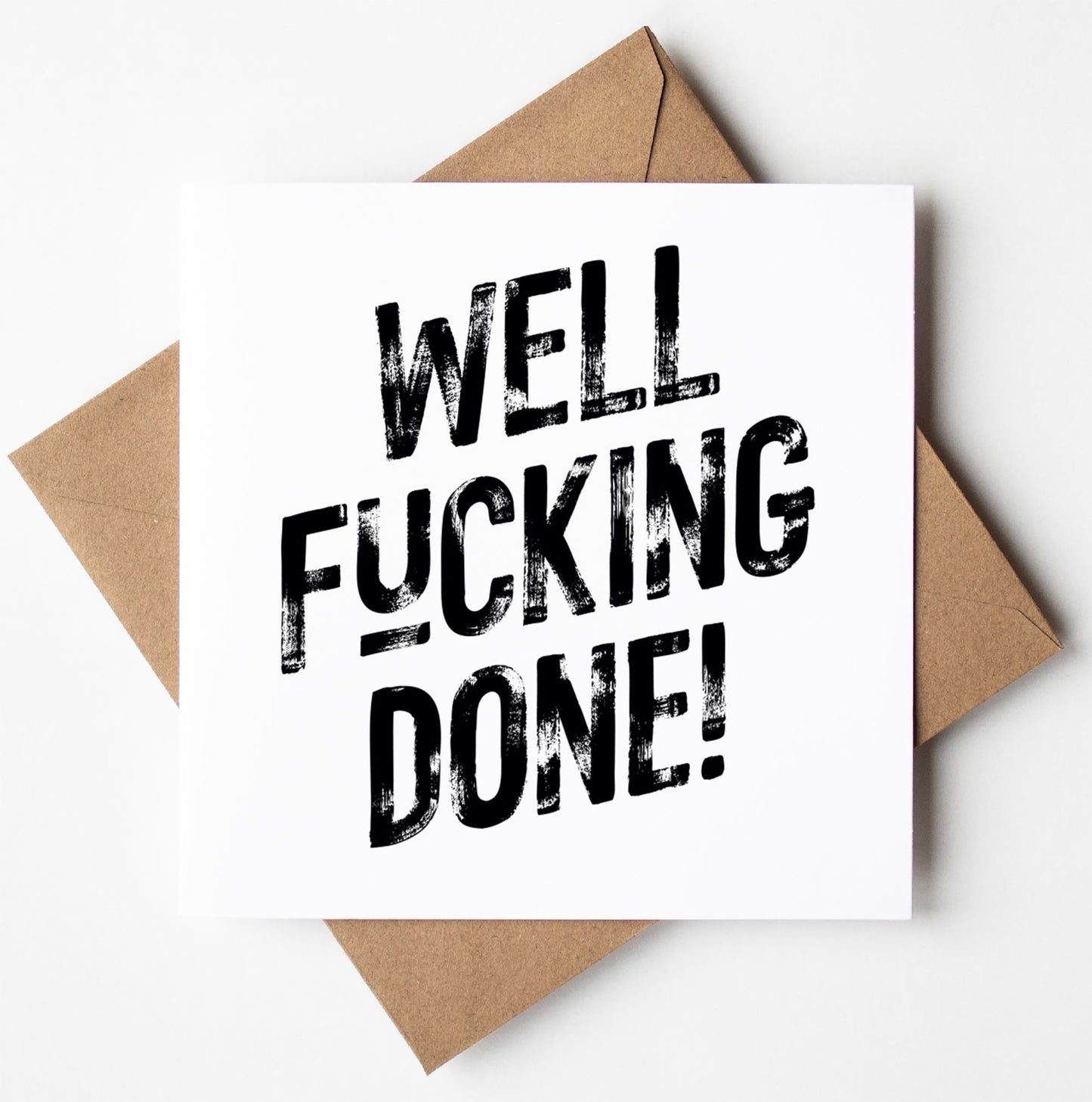 The "Well Fucking Done! Harlem Card" showcases bold black text on a white background, making for the perfect sweary congratulations card. It is elegantly displayed on top of a brown envelope.