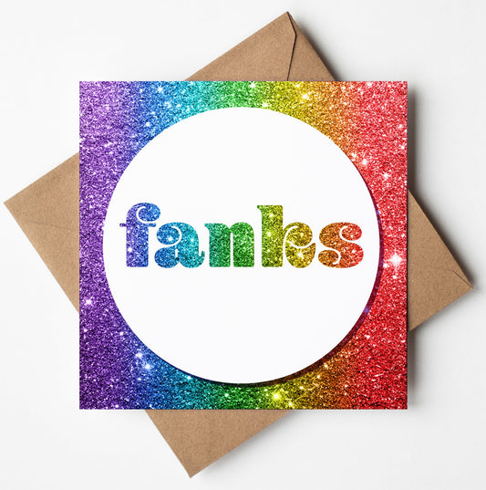 The Fanks Rainbow Glitter Card showcases the word "fanks" in bold, glittery letters on a white circular center. This greeting card is accompanied by biodegradable packaging and includes a brown envelope, offering an eco-friendly option for expressing gratitude.