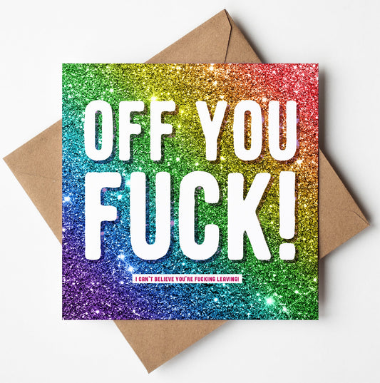 The "Off You Fuck! Rainbow Glitter Card" boldly displays "OFF YOU FUCK!" in striking white text, followed by the playful message "I CAN'T BELIEVE YOU'RE FUCKING LEAVING!" underneath. It comes neatly paired with a brown envelope and is available for worldwide shipping, making it ideal for sending off distant goodbyes.