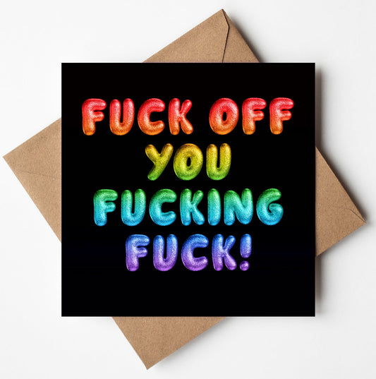 A vivid rainbow font spells out "Fuck Off You Fucking Fuck!" with colorful 3D letters against a black background, featuring gradients of red, orange, yellow, green, blue, and purple. Below the striking design is a brown envelope prepared for worldwide shipping.