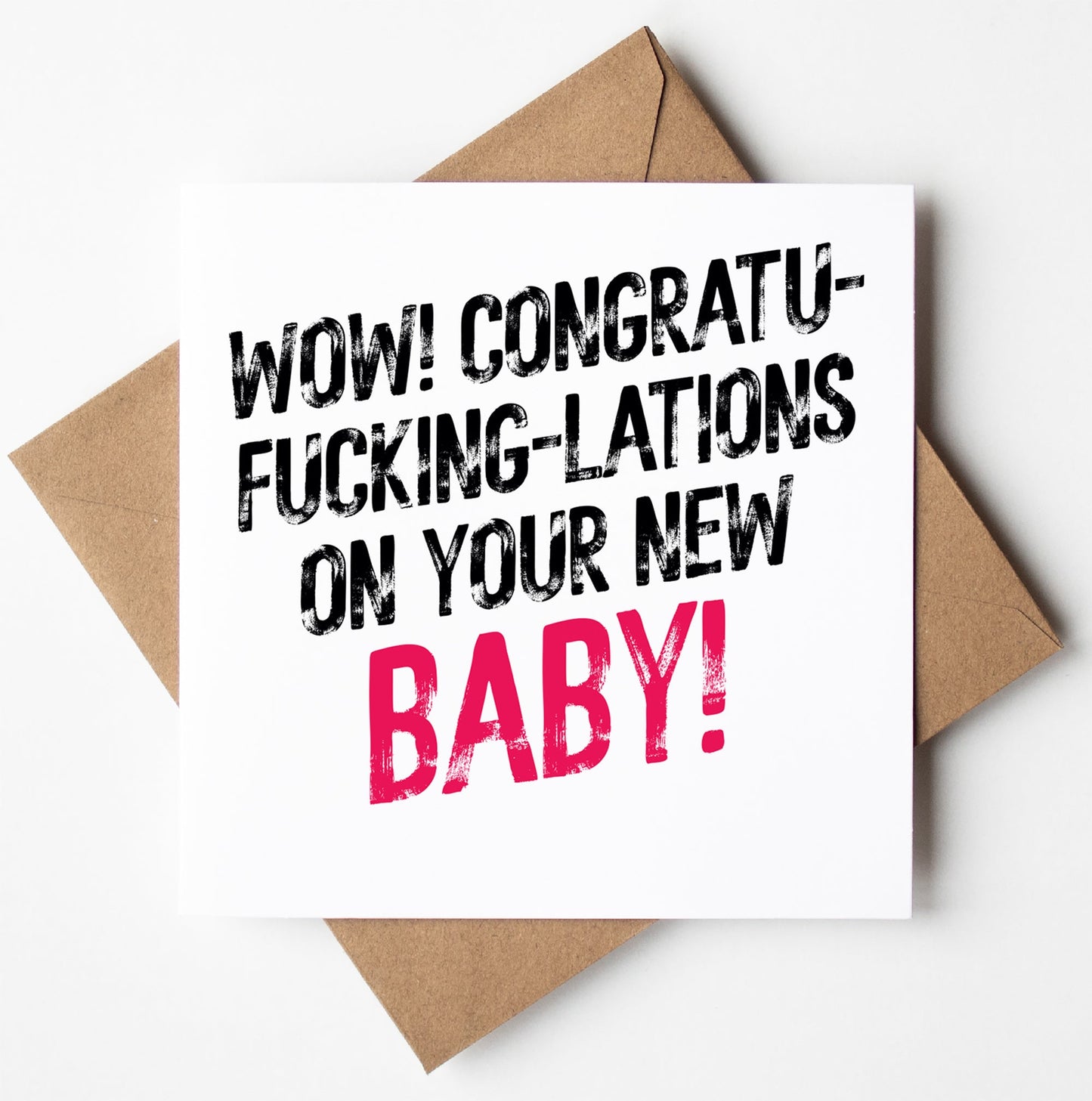The "Congrats On Your New Baby! Harlem Card" features bold text that humorously reads, "Wow! Congratufuckinglations on your new baby!" with the word "baby" highlighted in pink. Designed in Wales, the card is set on a brown envelope.