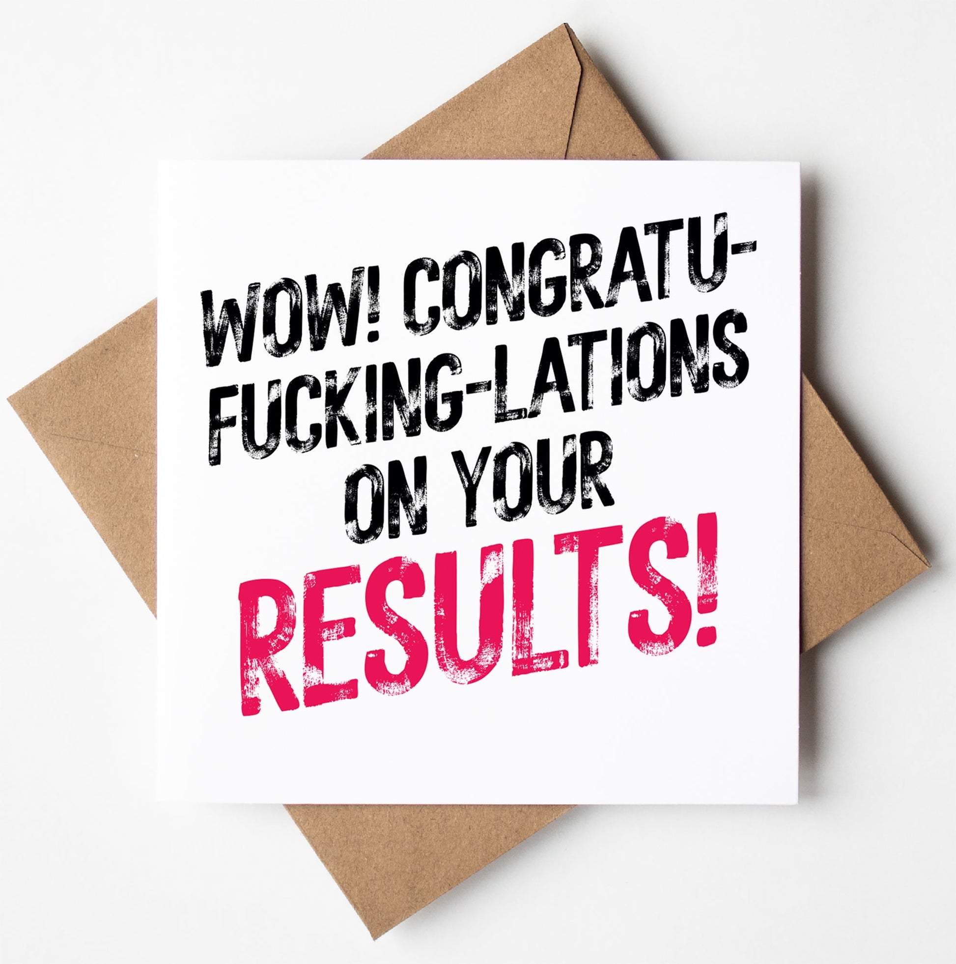 The "Congratu-fucking-lations On Your Results! Harlem Card," featuring bold black and pink lettering on a white card, rests on a brown envelope against a white backdrop. Ideal for stylishly expressing excitement.