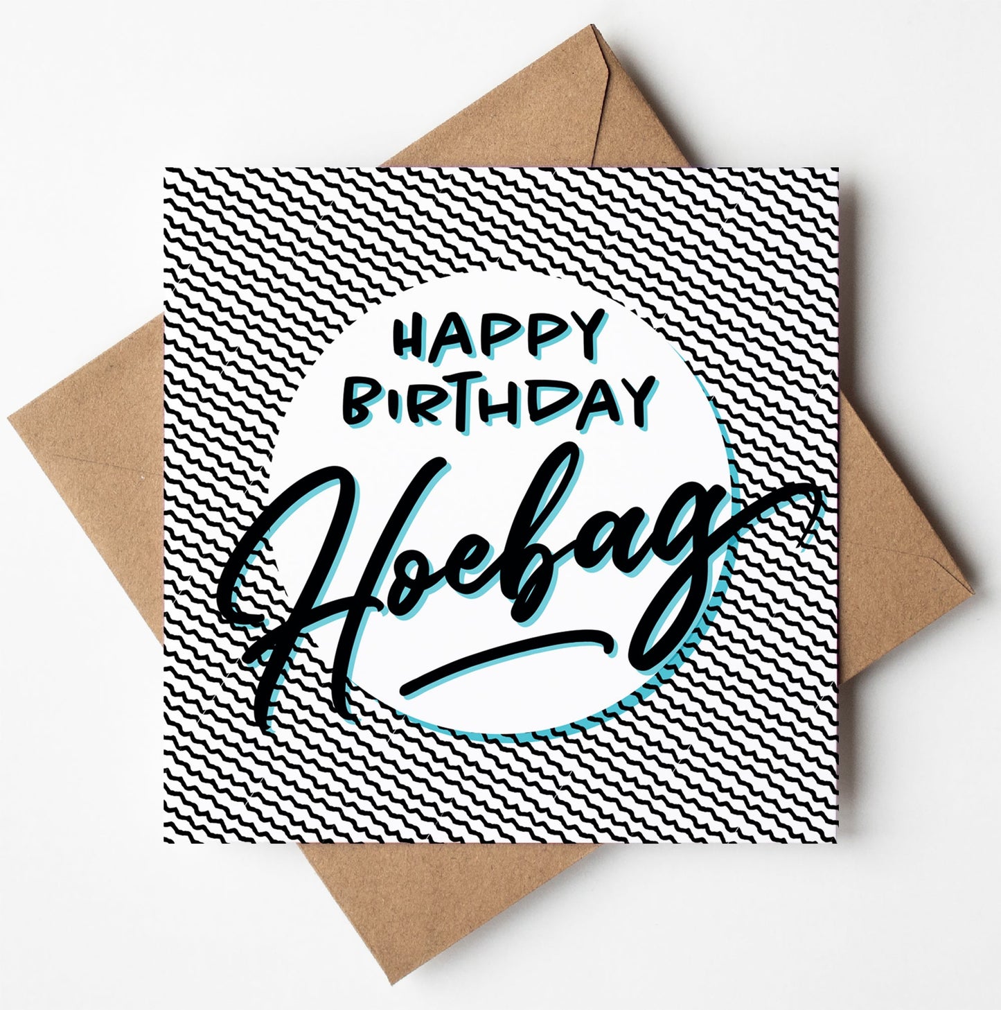 Introducing the "Happy Birthday Hoebag" Card, featuring a striking black and white zigzag pattern as its backdrop. The card showcases bold, stylized text that reads "Happy Birthday Hoebag," and comes accompanied by a brown envelope, making it perfect for worldwide shipping.