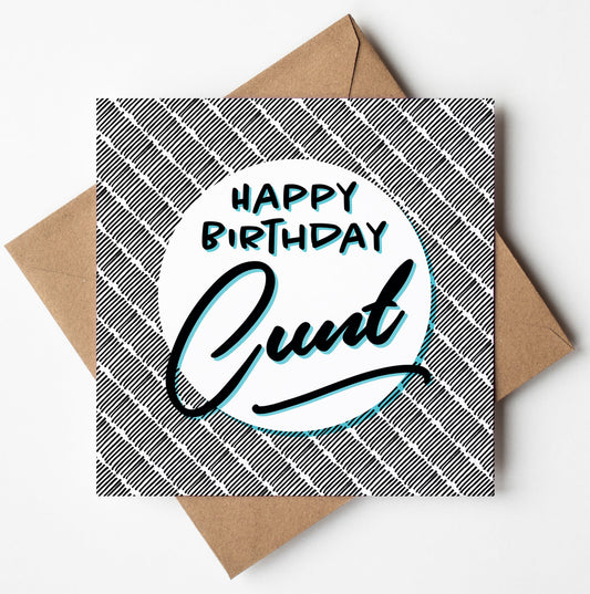 A Wales-designed card, titled "Happy Birthday Cunt!", features a bold plaid black and white pattern on the cover with the text prominently displayed. Set elegantly against a crisp white backdrop, it rests on a brown envelope, blending tradition with charm.