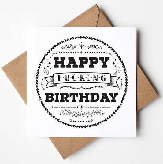 The "Happy Fucking Birthday! Scandi Card" is a square birthday card presented in a brown envelope, showcasing the words "Happy Fucking Birthday" in bold black letters. It is encircled by a decorative border featuring intricate designs, offering a minimalist yet Scandi-style elegance.