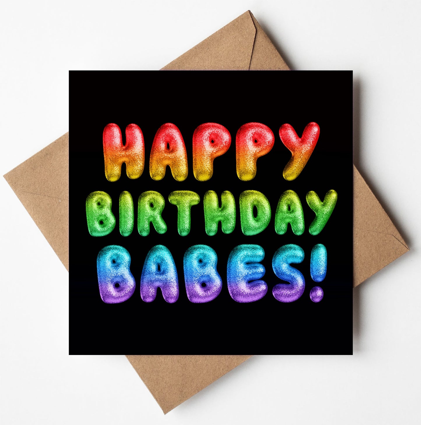 The Happy Birthday Babes! Rainbow Font Card, encased in a brown envelope, showcases textured letters declaring "Happy Birthday Babes!" against a black background. This lively card is both striking and available with worldwide shipping options, making it easy for your heartfelt wishes to reach loved ones anywhere.