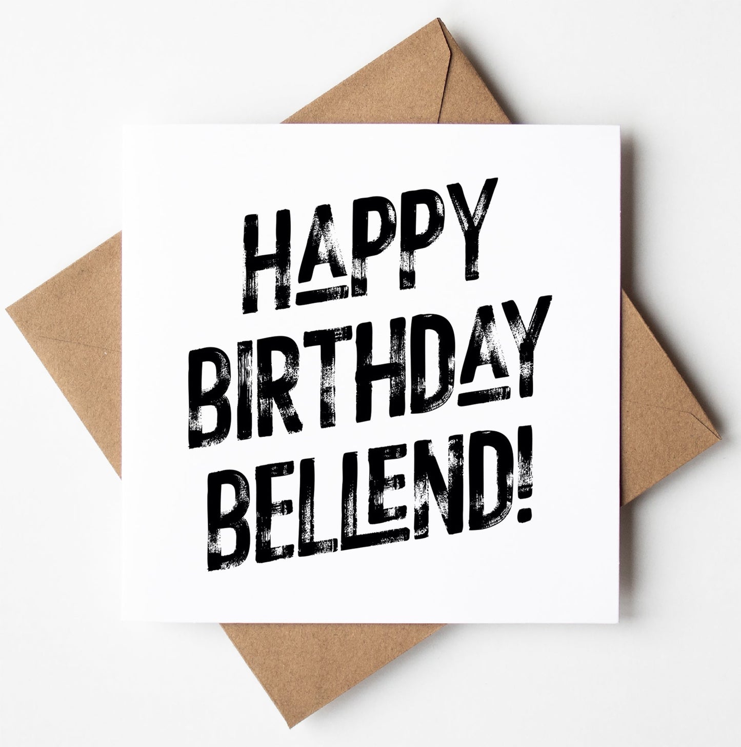 The "Happy Birthday Bellend! Harlem Card" features a white design with bold, black text that reads "HAPPY BIRTHDAY BELLEND!" It is displayed on a brown envelope against a white background and offers the convenience of worldwide shipping for easy delivery.