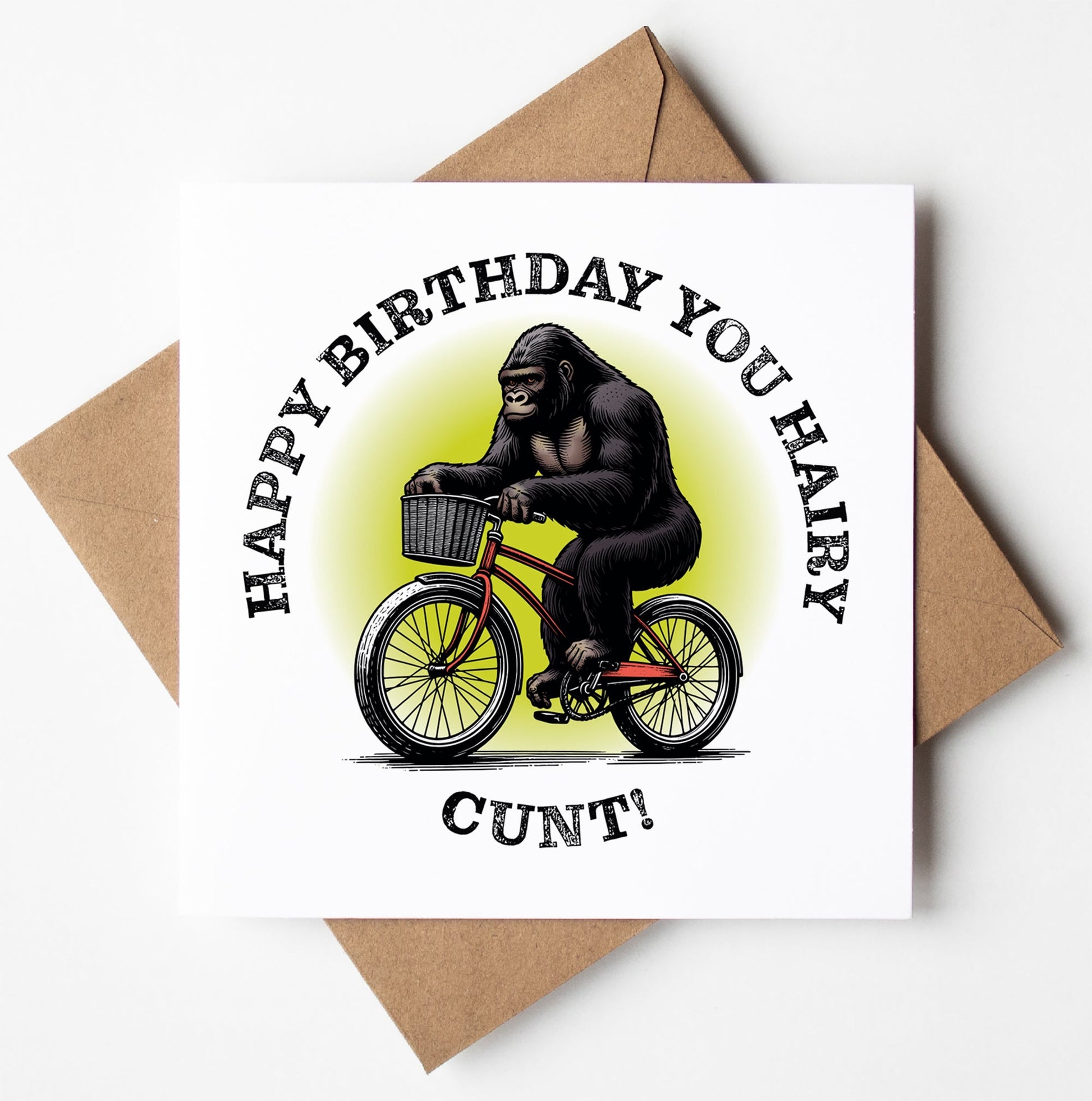 A humorous birthday card named "Happy Birthday You Hairy Cunt! Gorilla Card" showcases a gorilla riding a bicycle with the bold message "Happy Birthday You Hairy Cunt!" encircling the image. This cheeky card is carefully packaged in a brown envelope.
