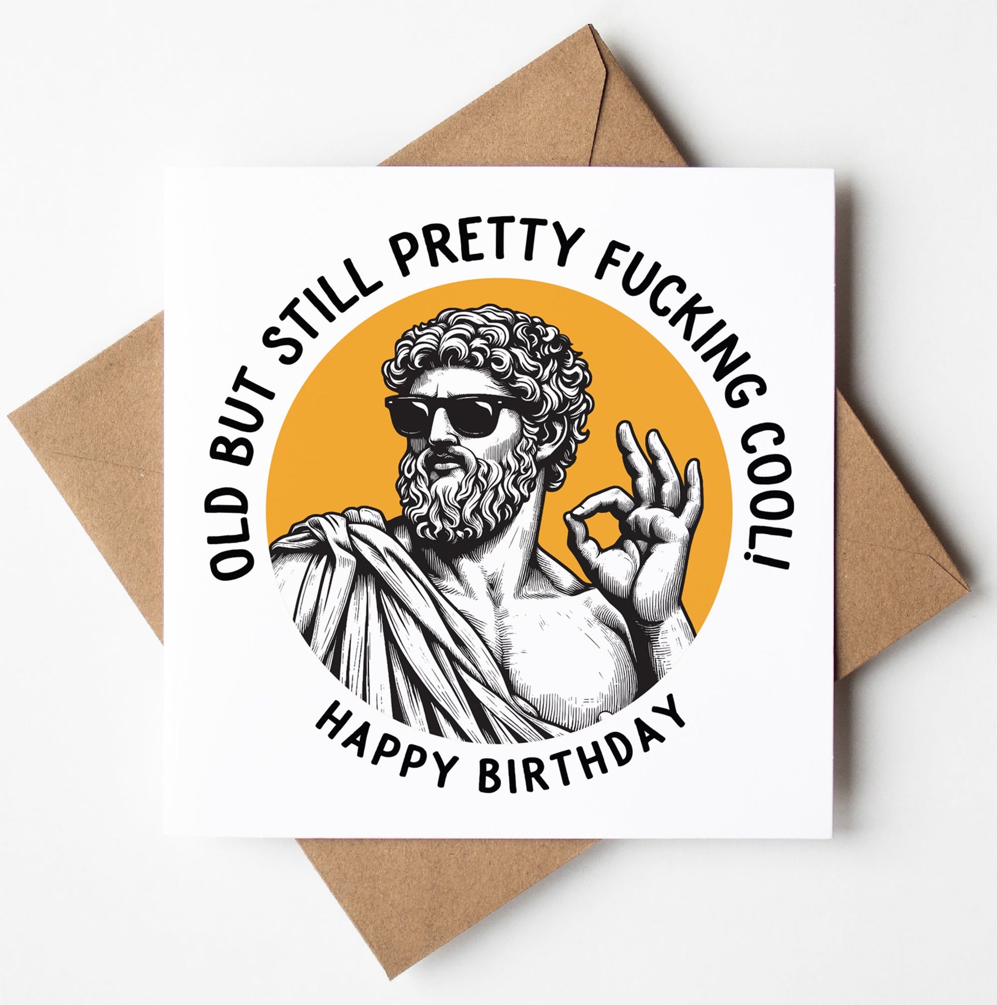 The "Old But Still Pretty Fucking Cool! Happy Birthday. Statue Dude Card" features a Roman statue in sunglasses making an "OK" gesture, with a brown envelope included. Perfect for a fun and unique birthday greeting!.