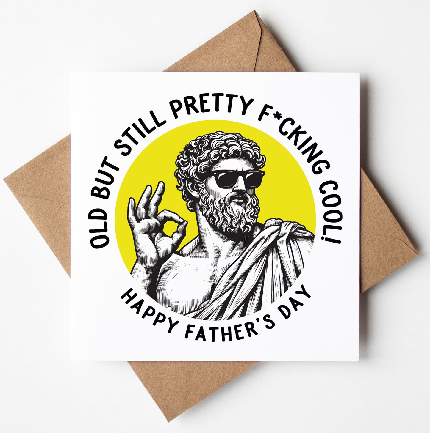 The Old But Still Pretty F*cking Cool! Happy Father's Day. Statue Dude Card features a statue-like figure in sunglasses making an "OK" sign, with the caption and comes complete with a brown envelope.