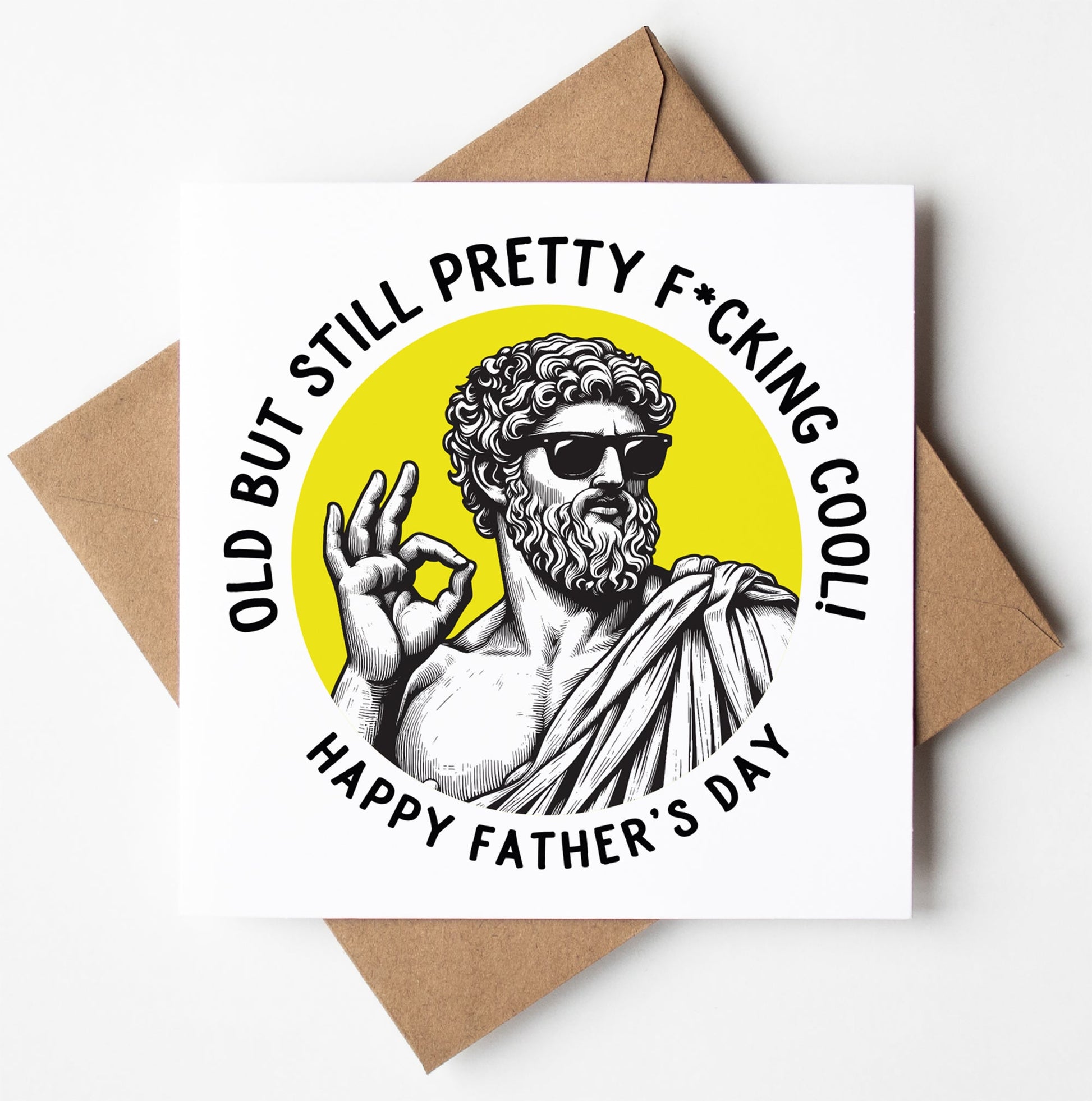 The Old But Still Pretty F*cking Cool! Happy Father's Day. Statue Dude Card features a statue-like figure in sunglasses making an "OK" sign, with the caption and comes complete with a brown envelope.
