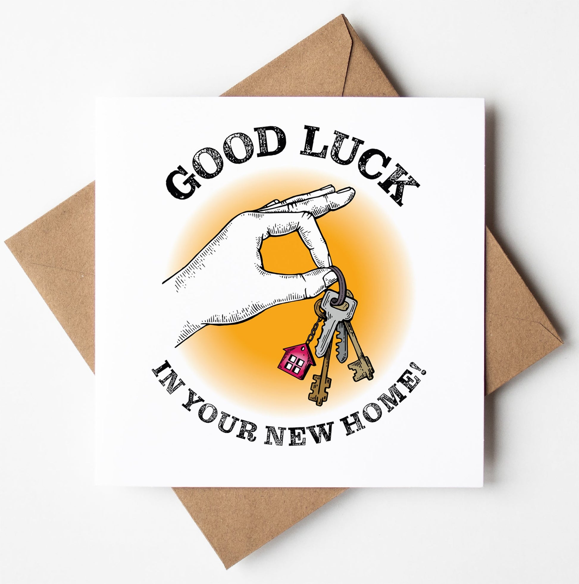 The "Good Luck in Your New Home Congratulations Keys Card" features a hand holding house keys adorned with a delightful red house keychain. The card's text reads, "GOOD LUCK IN YOUR NEW HOME!" and it comes with a brown envelope. Designed in Wales, it's an ideal way to congratulate someone on their new home.