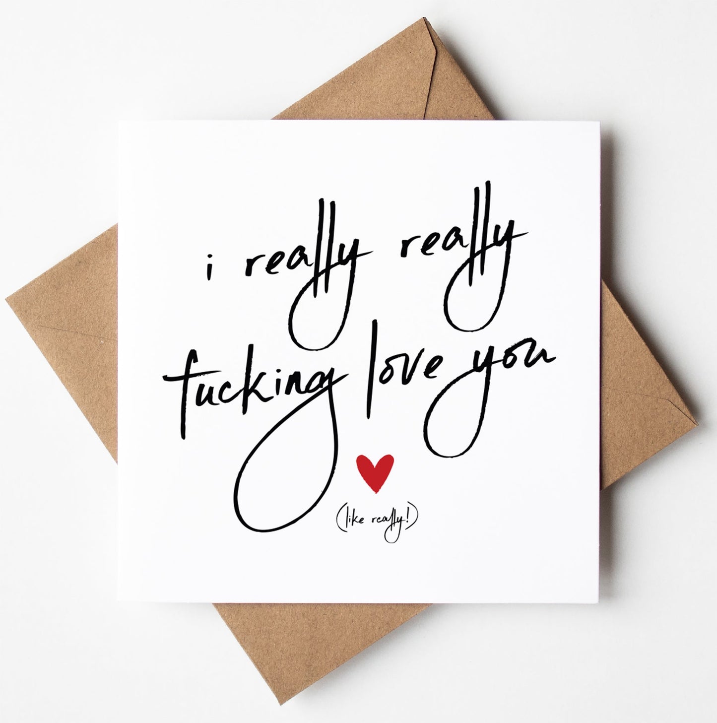 A card from the "I Really Really Fucking Love You" collection, featuring a handwritten message on a brown envelope and a small red heart—ideal for a humorous Valentine’s gesture.