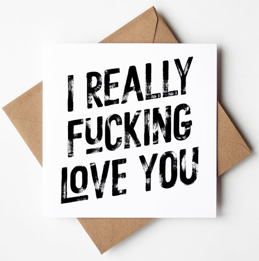 The "I Really Fucking Love You! Harlem Card" features a square design with bold black text that declares, "I REALLY FUCKING LOVE YOU," set atop a brown envelope against a white background. This cheeky, minimalist card is the ideal Valentine’s Day choice for anyone who values humor and sincerity equally.