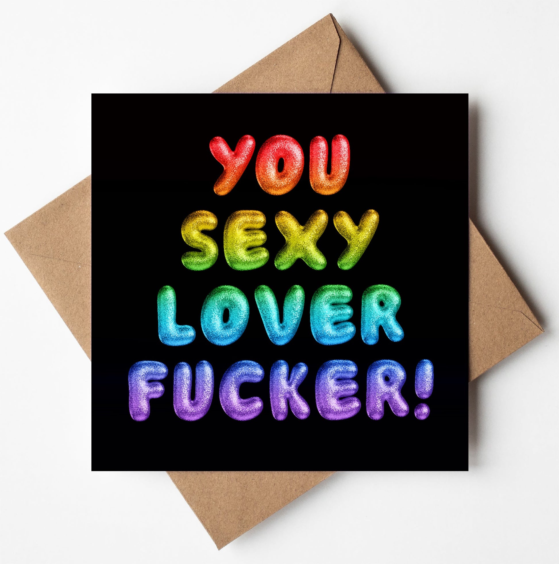 The "You Sexy Lover Fucker! Rainbow Font Card" features vibrant, balloon-style text on a black background. The words shine in bold gradient colors like red, orange, green, blue, and purple. Arranged in a square format with an envelope included, it's perfect for expressing bold affection.