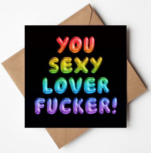 The "You Sexy Lover Fucker! Rainbow Font Card" features vibrant, balloon-style text on a black background. The words shine in bold gradient colors like red, orange, green, blue, and purple. Arranged in a square format with an envelope included, it's perfect for expressing bold affection.