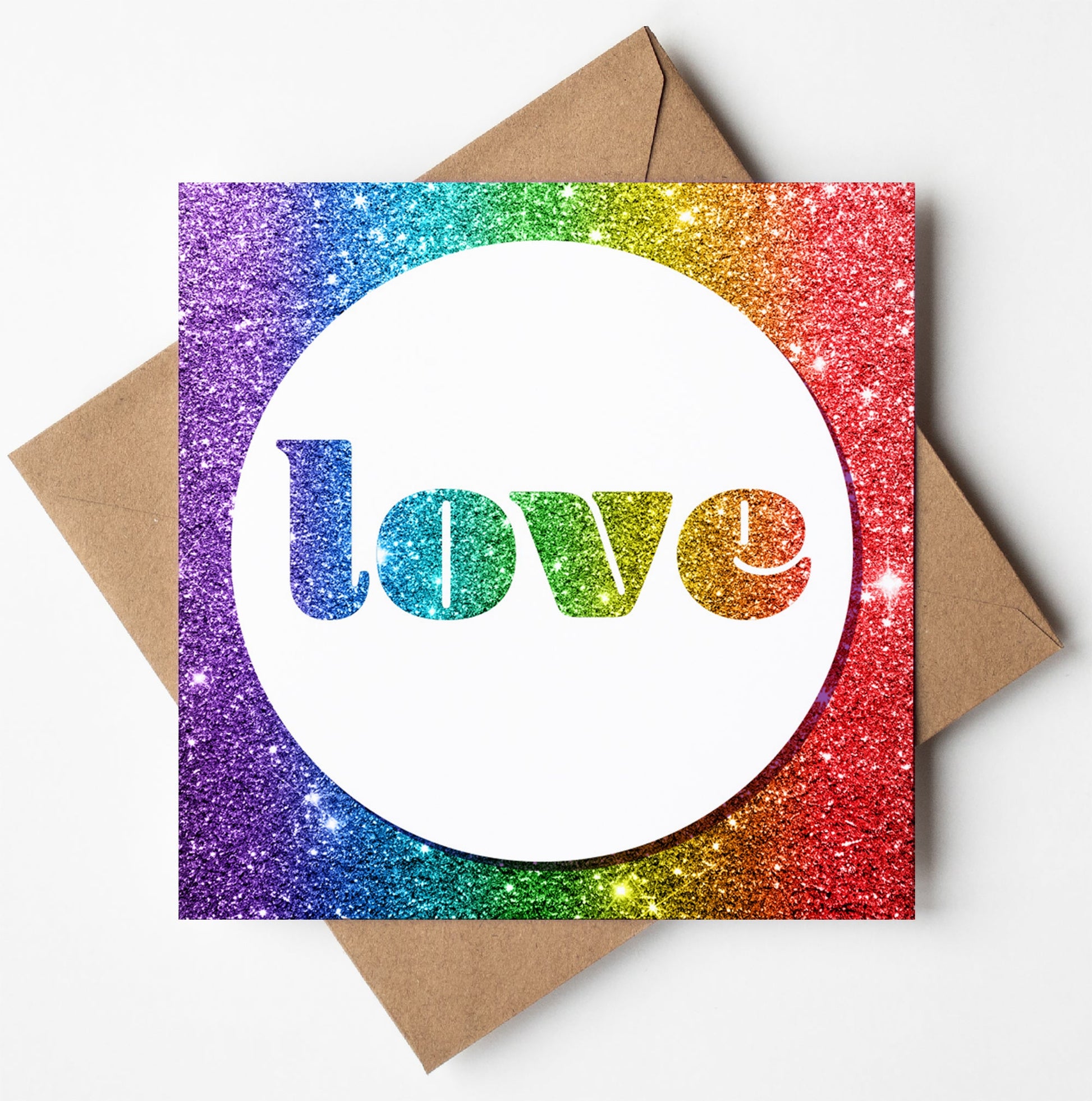 The Love Glitter Card boasts a vibrant design with the word "love" at its center, standing out against a dazzling rainbow-colored background, and is beautifully paired with a brown envelope.