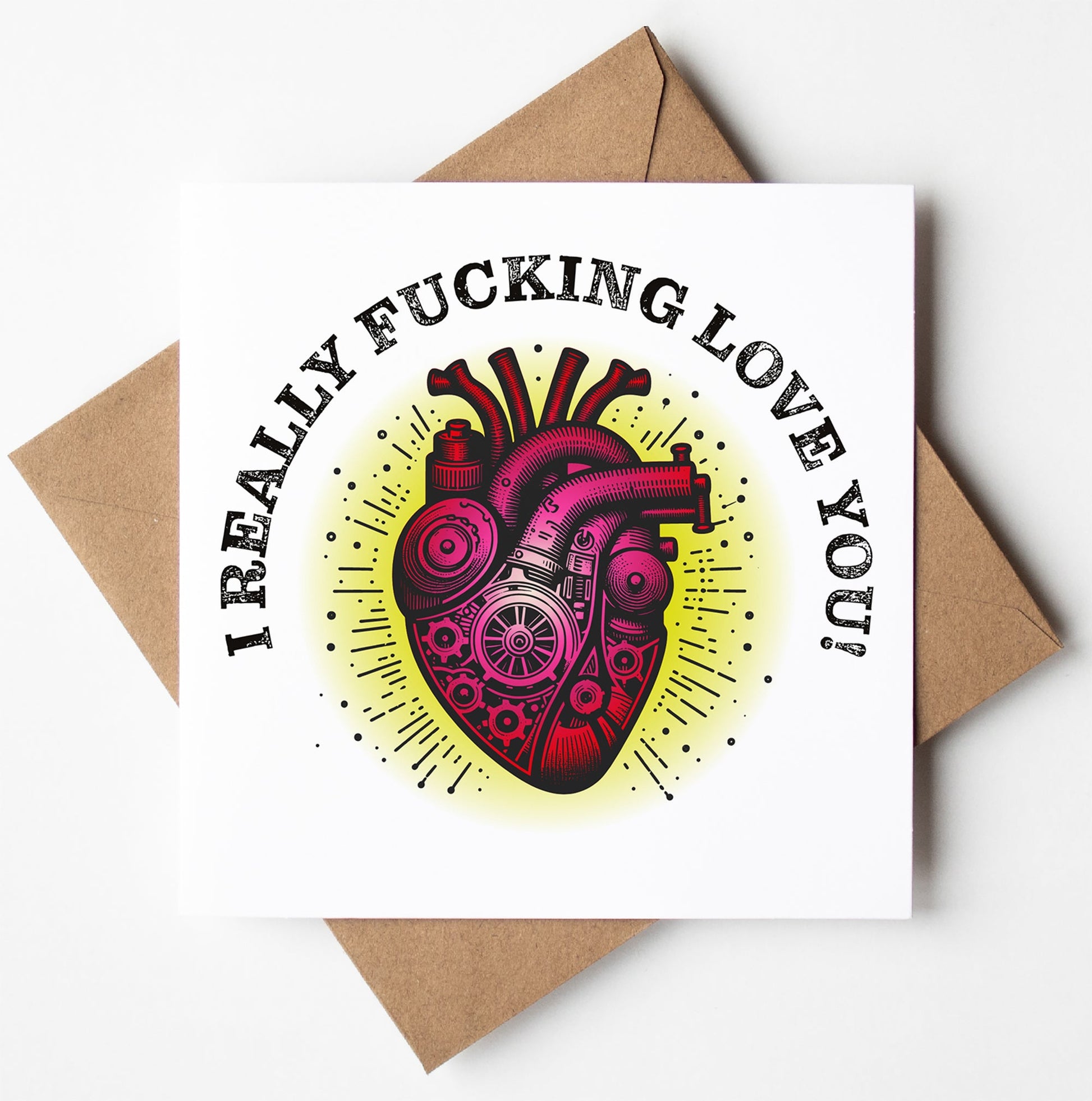 The "I Really Fucking Love You! Steampunk Heart Card" showcases an illustration of a mechanical heart adorned with pipes and gears. Bold black text above the design proclaims, "I REALLY FUCKING LOVE YOU!" The card is blank inside, perfectly presented on a brown envelope and available for worldwide shipping.