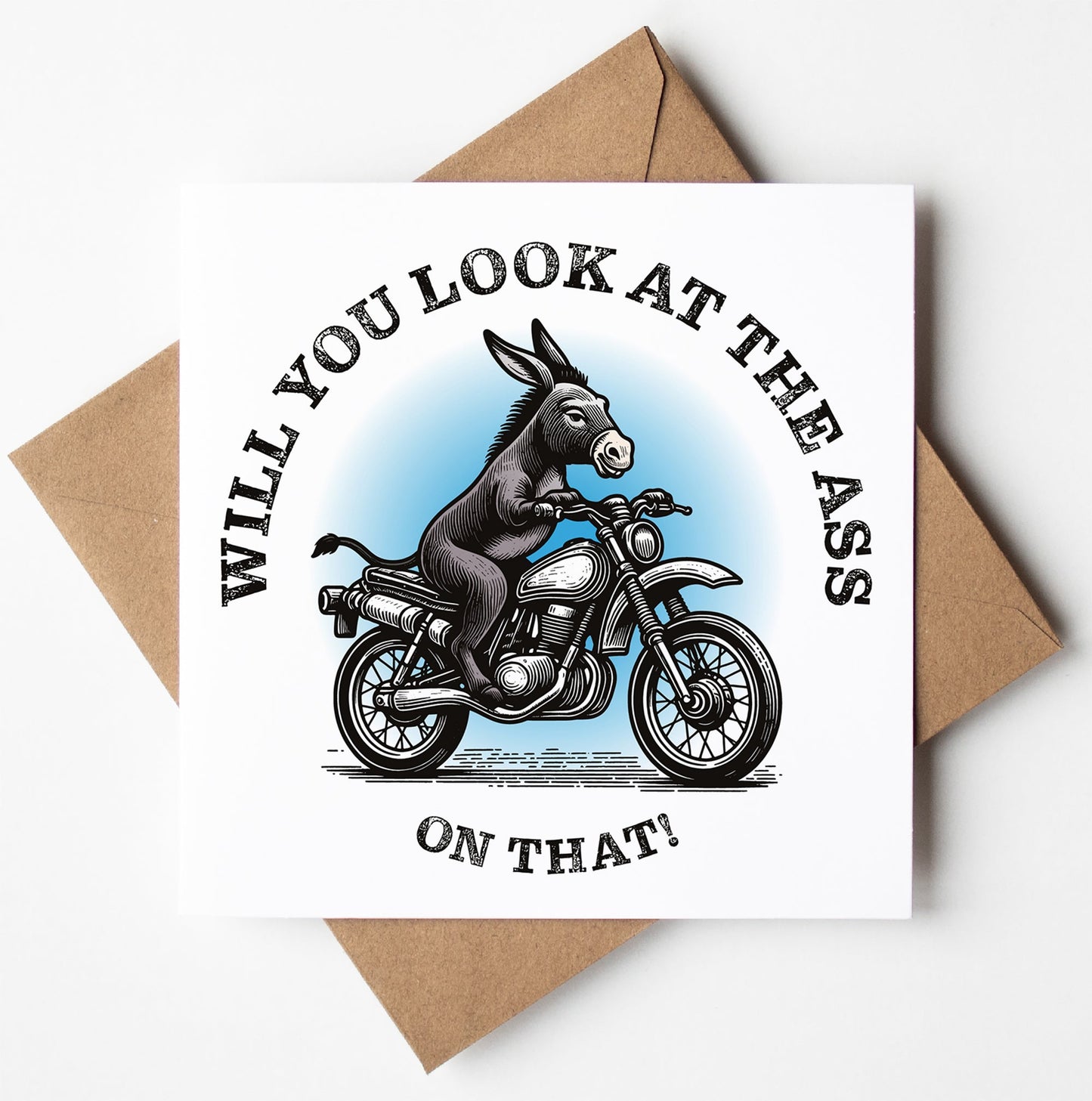 The "Will You Look At The Ass On That!" card features a cartoon donkey riding a motorcycle on its cover, with the humorous text, "WILL YOU LOOK AT THE ASS ON THAT!" It includes a brown envelope and is suitable for any occasion. Additionally, it ships in a biodegradable bag, making it ideal for worldwide shipping enthusiasts.