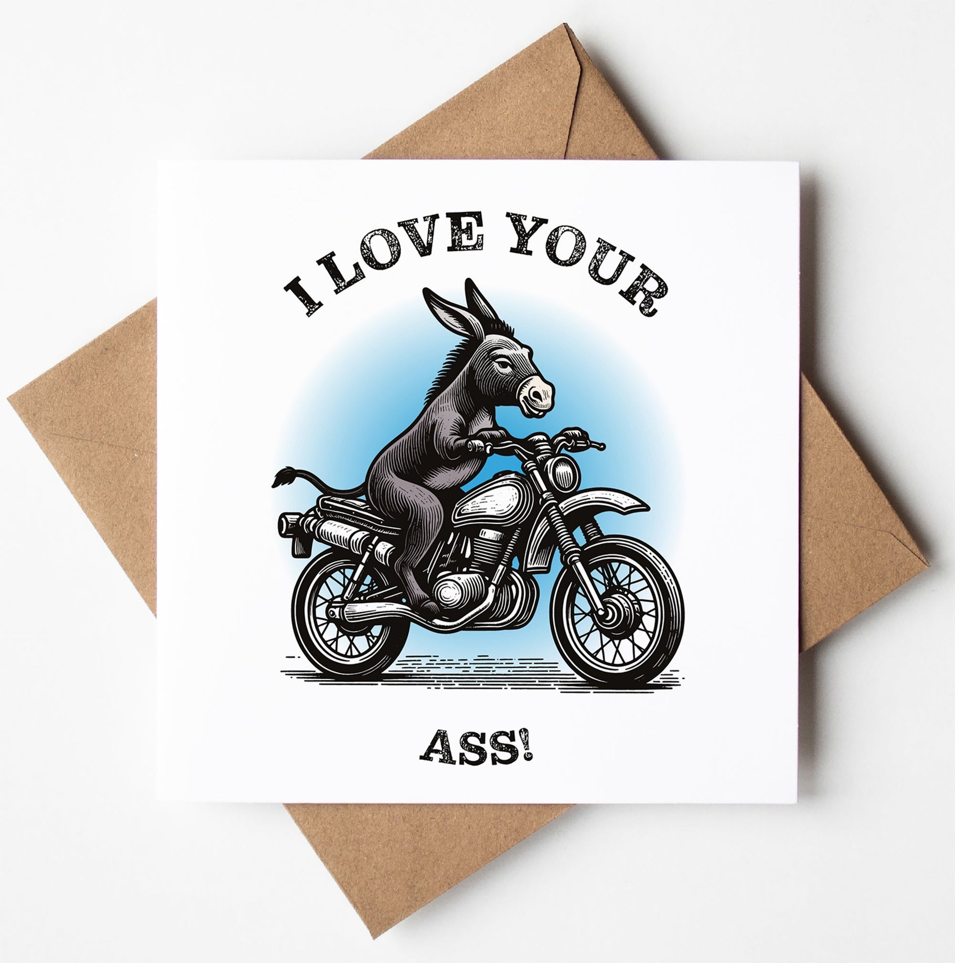 The "I Love Your Ass! Card" displays a playful illustration of a donkey on a motorcycle accompanied by bold text. It is delivered in a brown envelope and printed in the UK, adding an eco-friendly element to your message with its biodegradable materials.