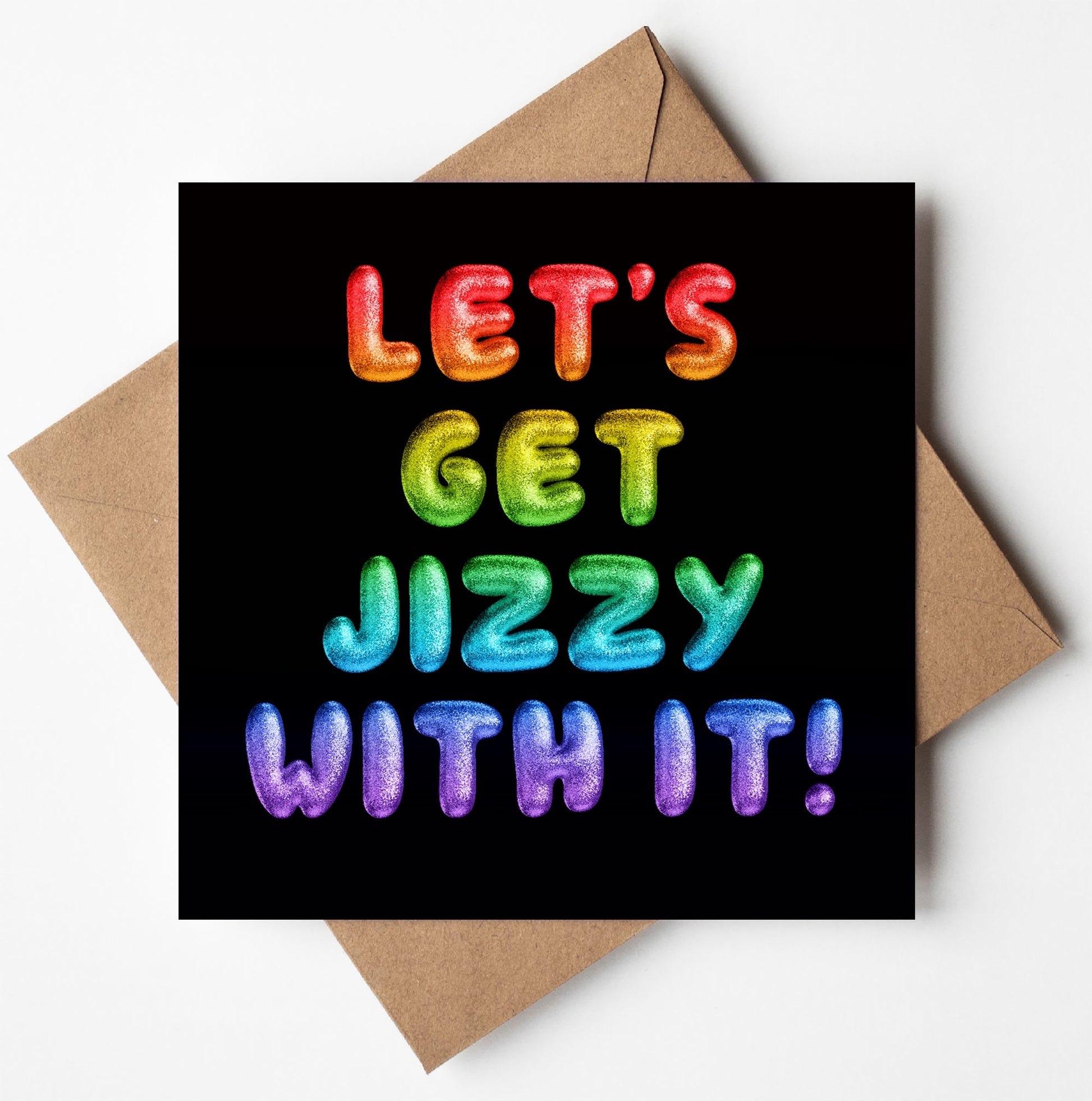 The "Let's Get Jizzy With It! Rainbow Font Card," a square card designed in Wales, is paired with a brown envelope. It features the phrase "LET'S GET JIZZY WITH IT!" in bold, colorful balloon-like letters. The playful text spans four rows with a vibrant rainbow gradient on a black background.