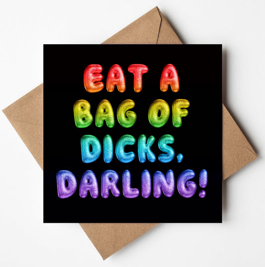 The "Eat A Bag Of Dicks, Darling! Rainbow Font Card" showcases vibrant 3D rainbow letters against a black backdrop. It comes with a brown envelope and offers worldwide shipping.
