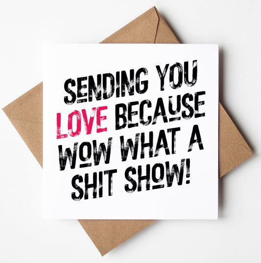 Inside a biodegradable bag lies the "Sending Love Because Wow What A Shit Show! Harlem Card," featuring an envelope with striking black text: "Sending you love because wow what a shit show!" The word "love" is highlighted in pink, primed for worldwide shipping.