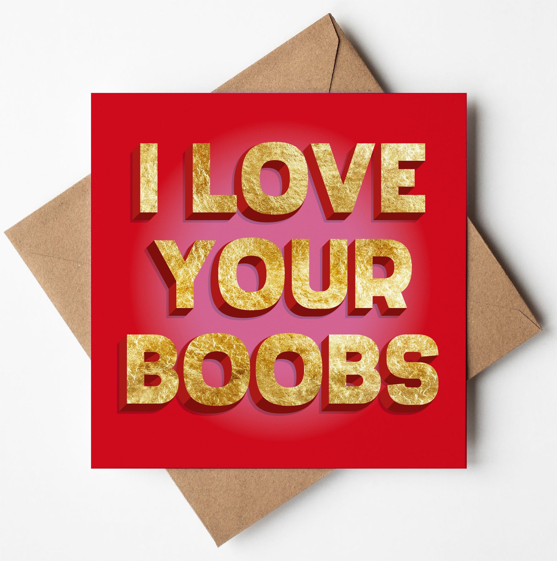 The "I Love Your Boobs Card" is a red Valentine card with bold, gold 3D text. The card rests on a brown envelope against a white background, capturing the playful spirit of a funny anniversary gift.