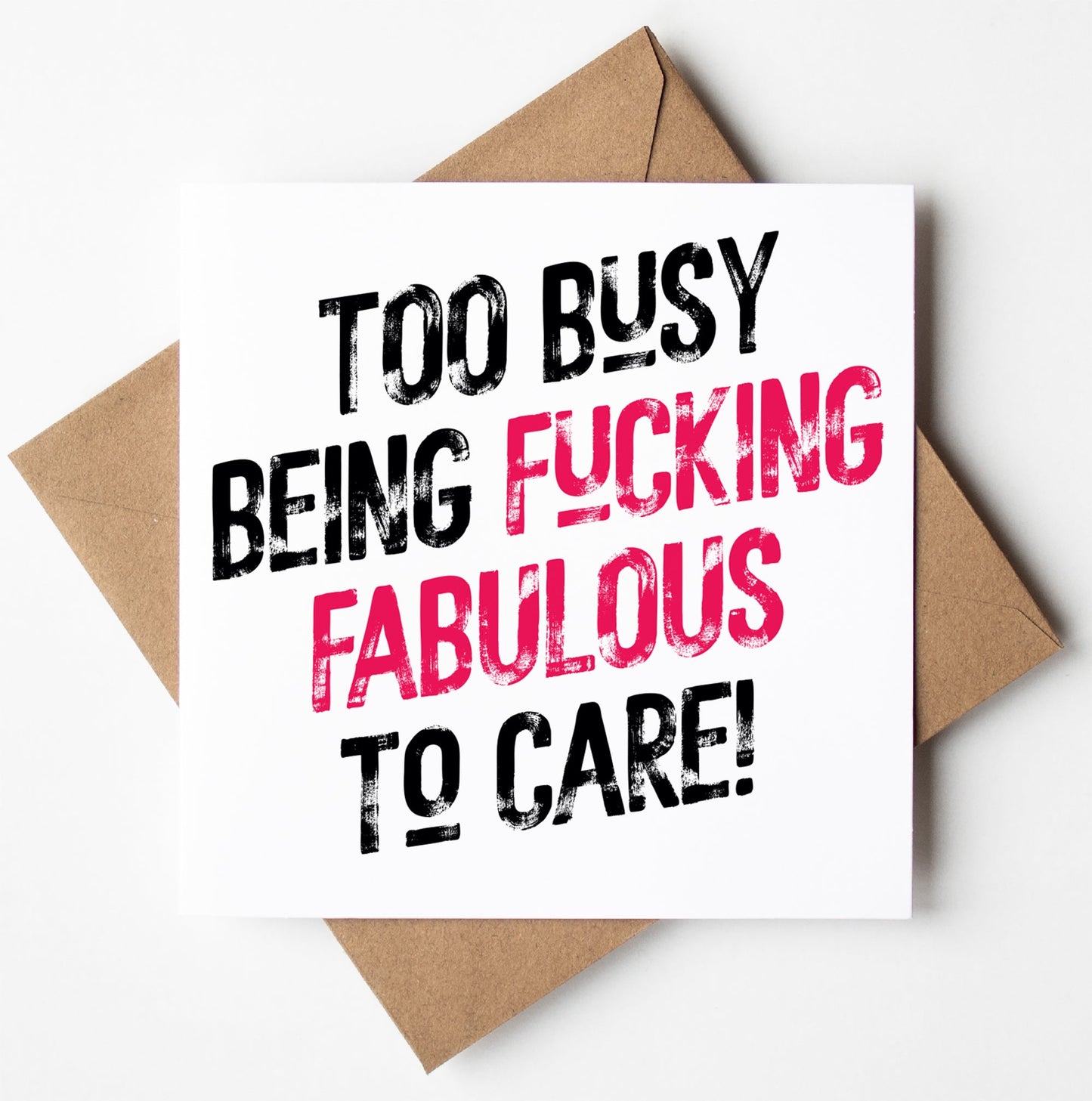 The "Too Busy Being Fucking Fabulous To Care! Harlem Card" showcases bold black and pink text on a white card with a brown envelope. Ideal as a sweary birthday card, it delivers the perfect declaration.