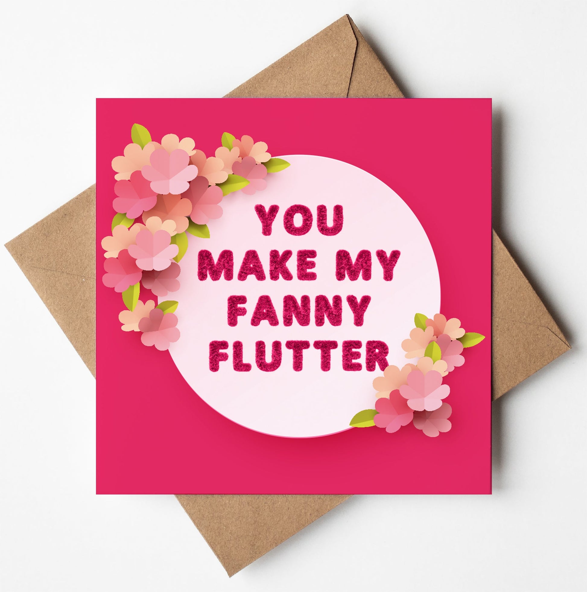 The "You Make My Fanny Flutter" card boasts a vibrant pink background and a circle surrounded by pink and peach flowers. Inside, the playful text: "YOU MAKE MY FANNY FLUTTER." Ideal for Valentine's Day, it comes with a brown envelope.