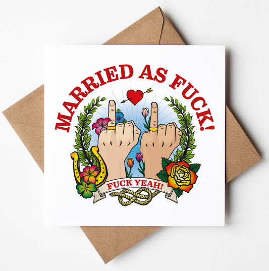 The Married As Fuck Tattoo Wedding Card (M/M) showcases a humorous square design with two raised middle fingers surrounded by a motif of flowers, leaves, and a heart. The card features the text "MARRIED AS FUCK!" at the top and "FUCK YEAH!" at the bottom, making it an ideal choice for a cheeky wedding card. It comes paired with a brown envelope.