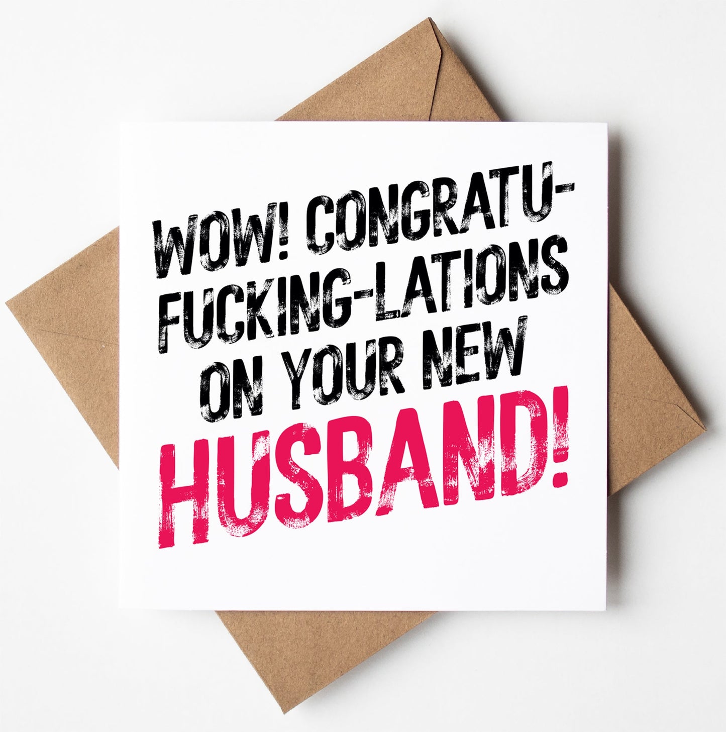The "Congratulations On Your New Husband! Sweary Wedding Card" features bold text that exclaims, "Wow! Congratu-fucking-lations on your new husband!" This cheeky card is displayed against a brown envelope and comes in a biodegradable bag, with the inside left blank for your personal message.