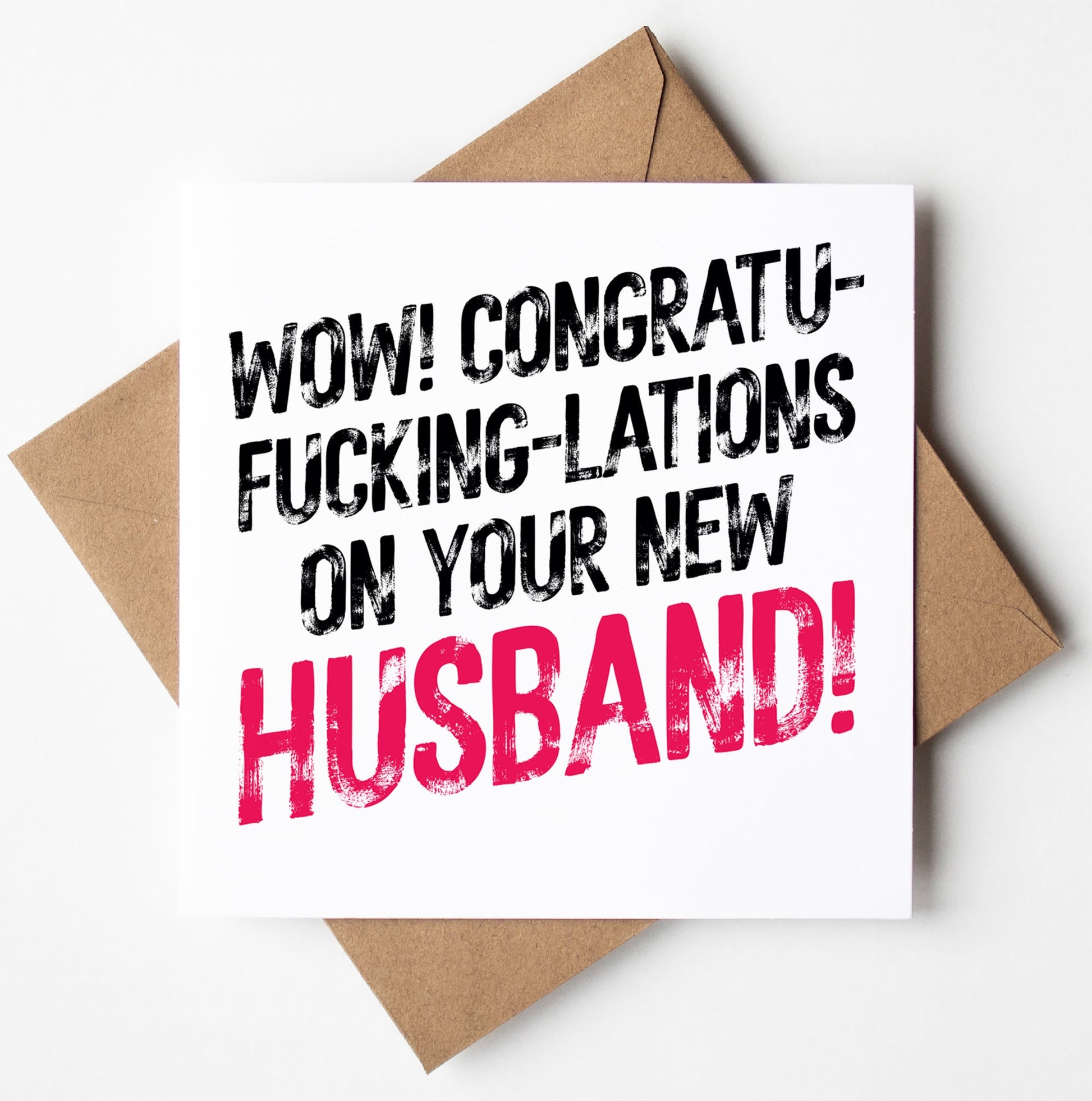 The "Congratulations On Your New Husband! Sweary Wedding Card" features bold text that exclaims, "Wow! Congratu-fucking-lations on your new husband!" This cheeky card is displayed against a brown envelope and comes in a biodegradable bag, with the inside left blank for your personal message.