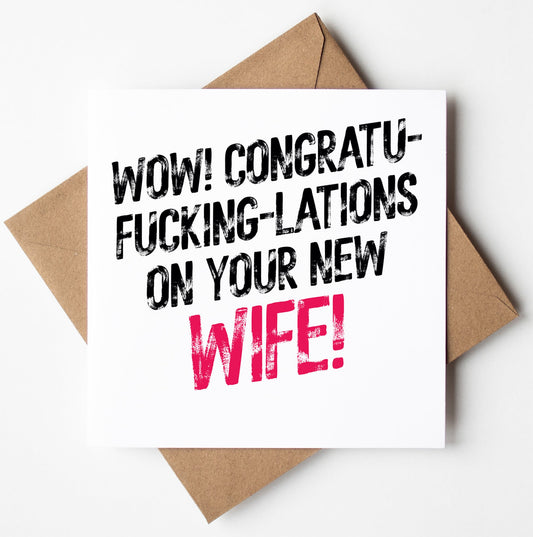 A Harlem Wedding Card with a bold twist arrives in a brown envelope, featuring black and pink text that shouts, "WOW! CONGRATU-FUCKING-LATIONS ON YOUR NEW WIFE!" Designed in Wales, this card is perfect for those wanting to make a statement.