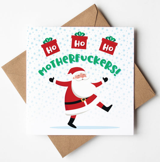A Funny Christmas card featuring an animated Santa Claus with the text "Ho Ho Ho MOTHERFUCKERS!" and three gift icons above. Perfect for those who appreciate naughty Xmas humour, this adult Xmas card is placed on a rustic brown envelope.