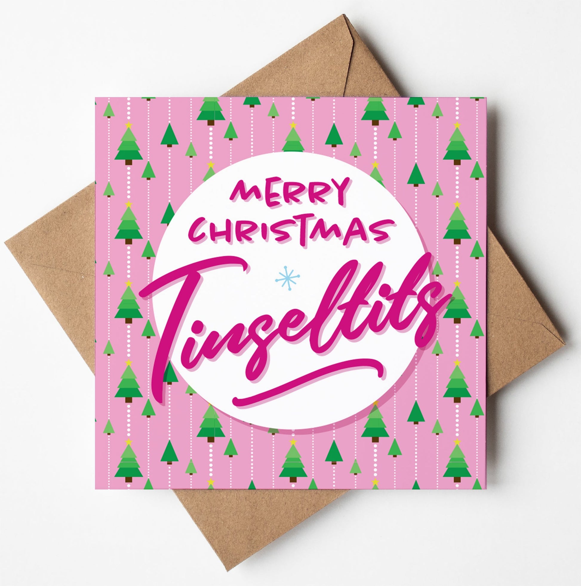 The Merry Christmas Tinseltits Trees Pink Card showcases small green trees arranged diagonally on a pink background and comes with a biodegradable brown envelope. A white circle in the center displays the words "Merry Christmas Tinsel Tits" in pink text, making it an ideal choice for spreading cheer internationally.
