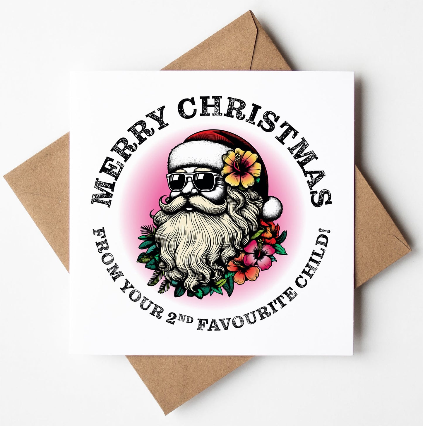 Here's a humorous Christmas card titled "Sunglass Santa's Merry Xmas From Your 2nd Favourite Child Card." It features a cool Santa wearing sunglasses, with a flower in his hat and a floral beard. Embracing playful Christmas humor, the text reads "Merry Christmas from your 2nd favourite child!" It comes perfectly paired with its brown envelope.