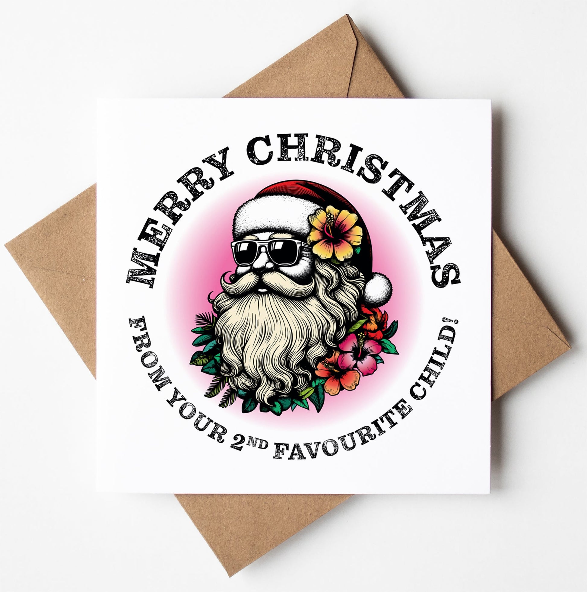 Here's a humorous Christmas card titled "Sunglass Santa's Merry Xmas From Your 2nd Favourite Child Card." It features a cool Santa wearing sunglasses, with a flower in his hat and a floral beard. Embracing playful Christmas humor, the text reads "Merry Christmas from your 2nd favourite child!" It comes perfectly paired with its brown envelope.