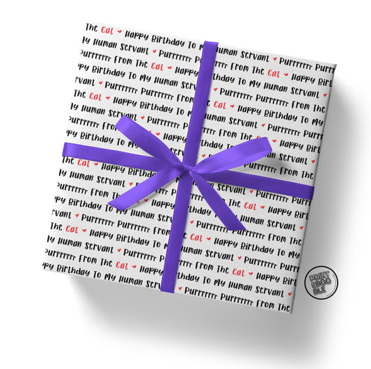 A gift box is elegantly wrapped in the Human Cat Servant Birthday Gift Wrap (Folded Sheet), featuring a cat-themed design with black and red text repeatedly stating "Happy Birthday to my human servant. Purrrrrr from the cat." It is beautifully tied with a purple ribbon and bow, making it the perfect gift for any kitty's mum.